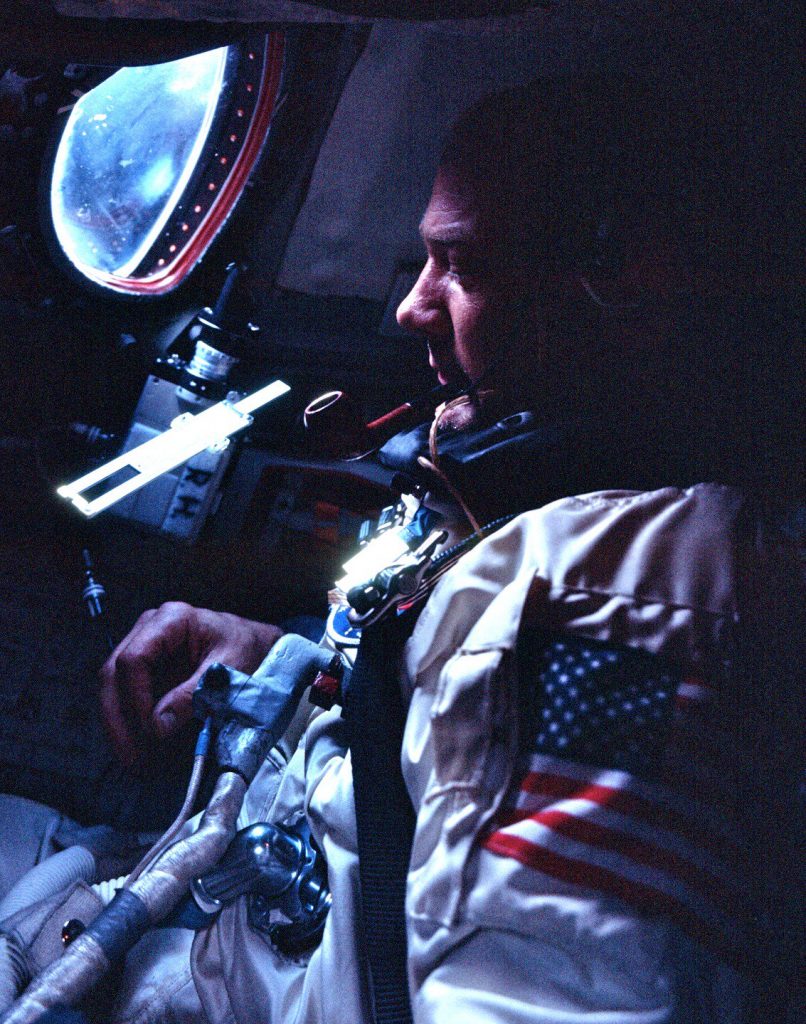 Buzz Aldrin and a floating slide rule during Gemini 12 on 1966 November 13 (NASA).