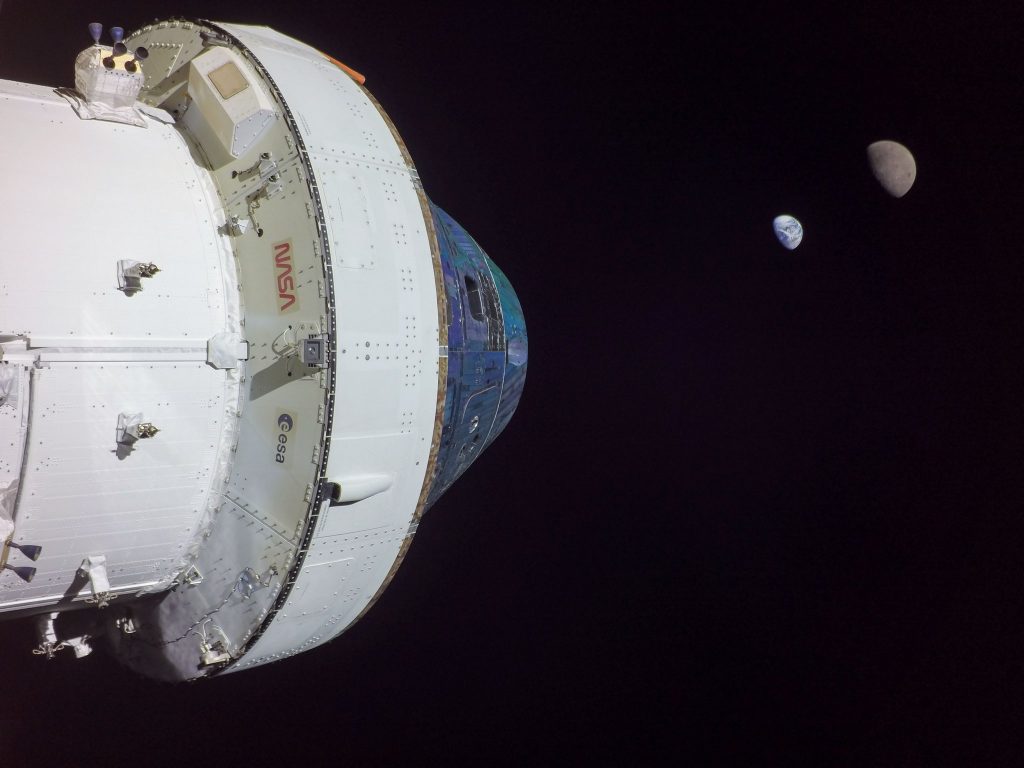From a distant retrograde orbit, a camera at the tip of an Orion solar panel photographs Earth and Moon, 2022 November 28.